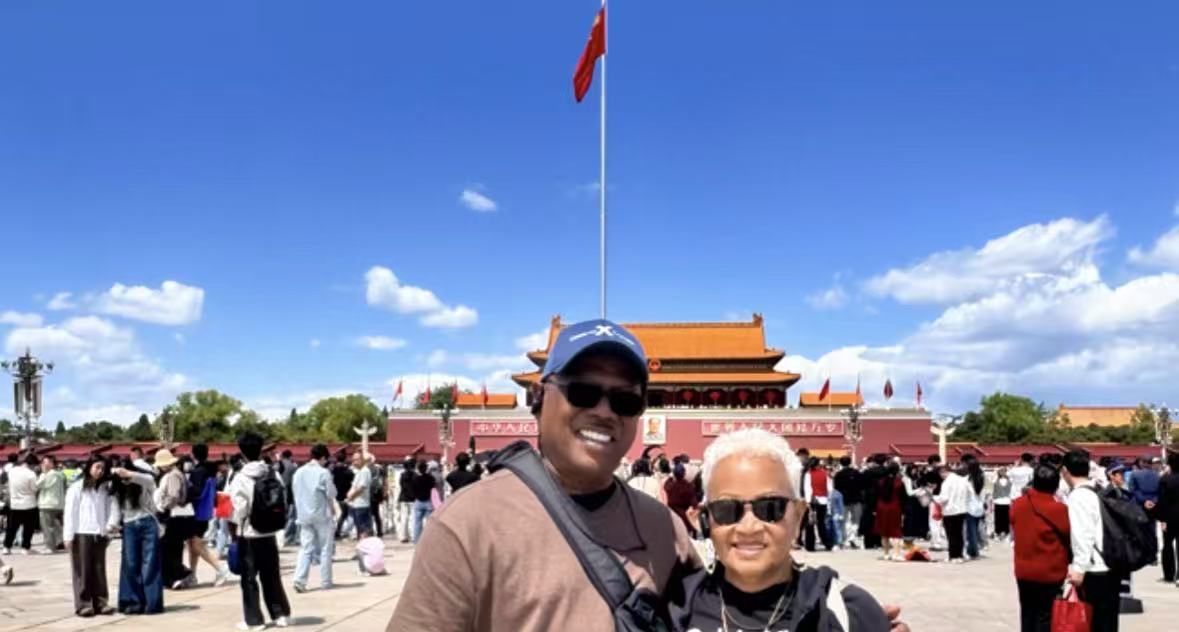 Couple guests under the flag at Tiananmen Square