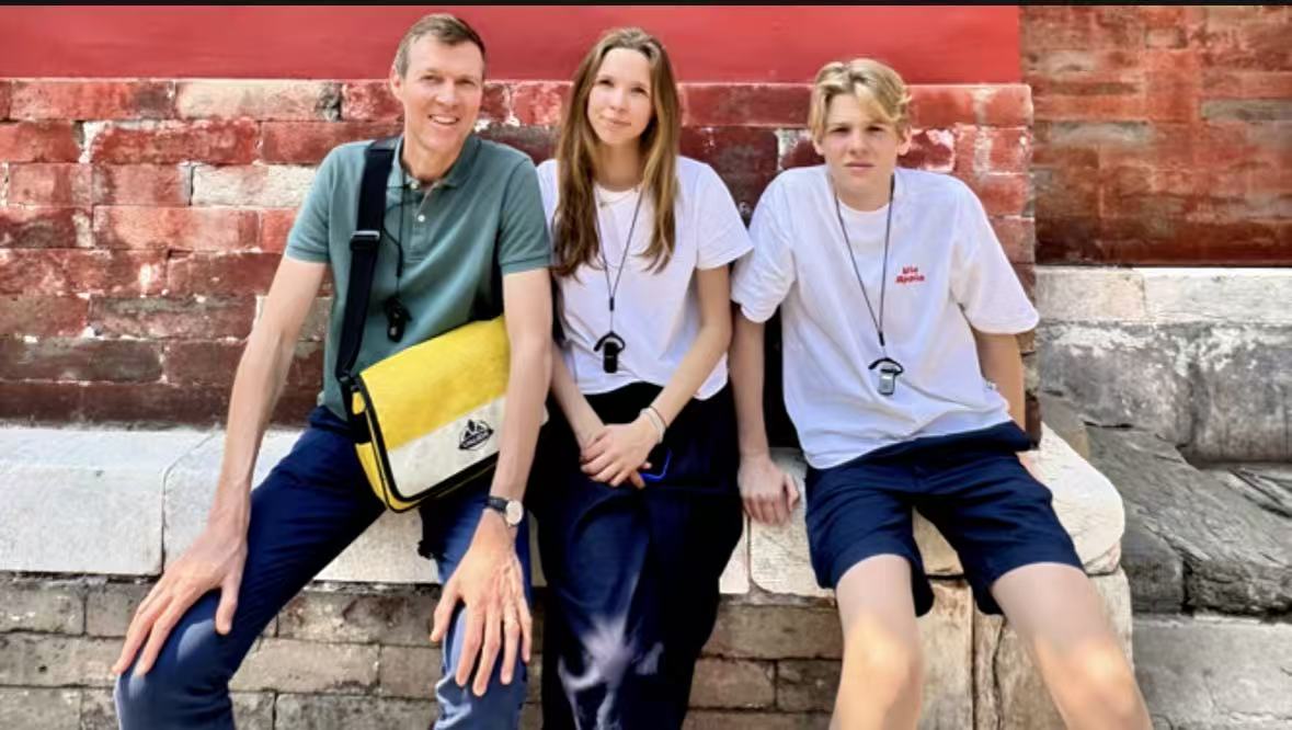 Family guests resting by a palace wall