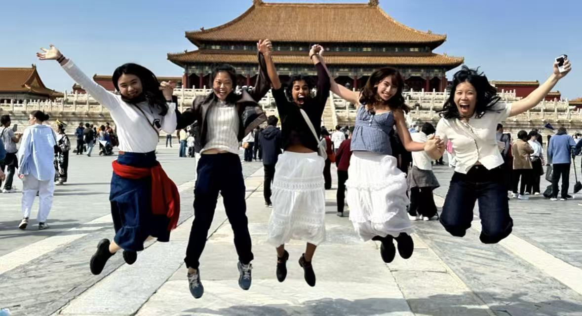 Guests jumping happily inside the Forbidden City